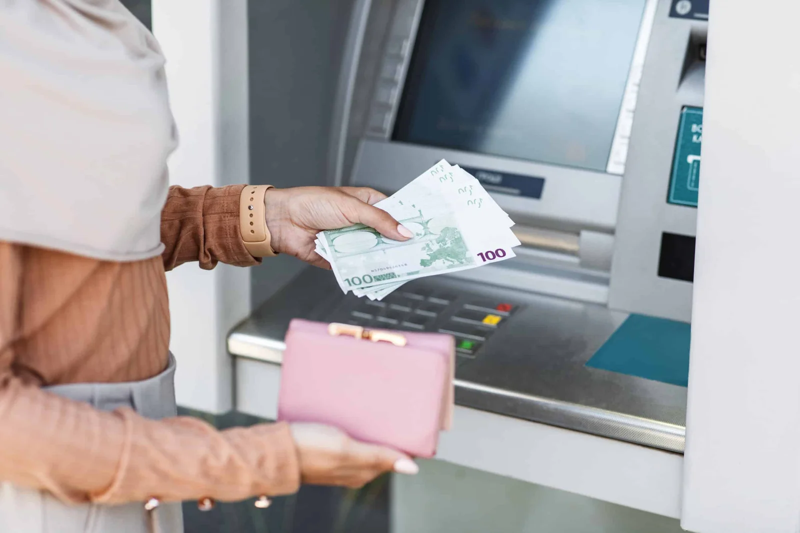 cropped young arab lady holds a lot of euros and a wallet