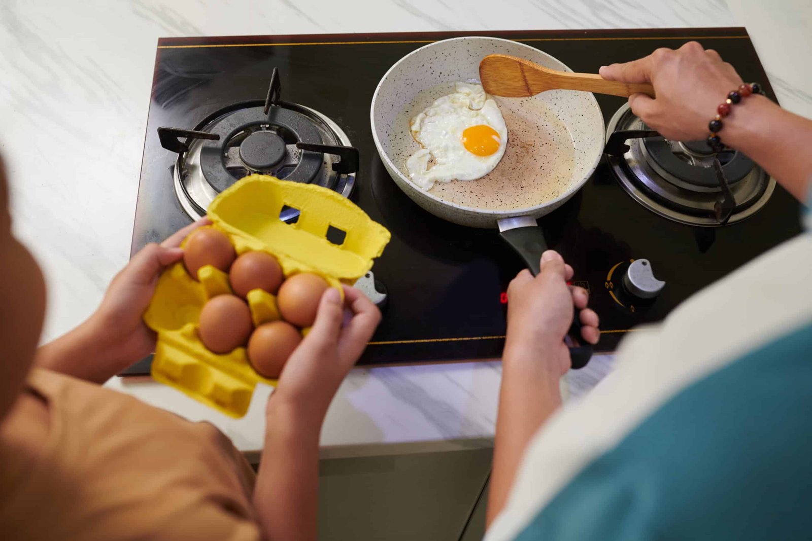 father and son cooking breakfast